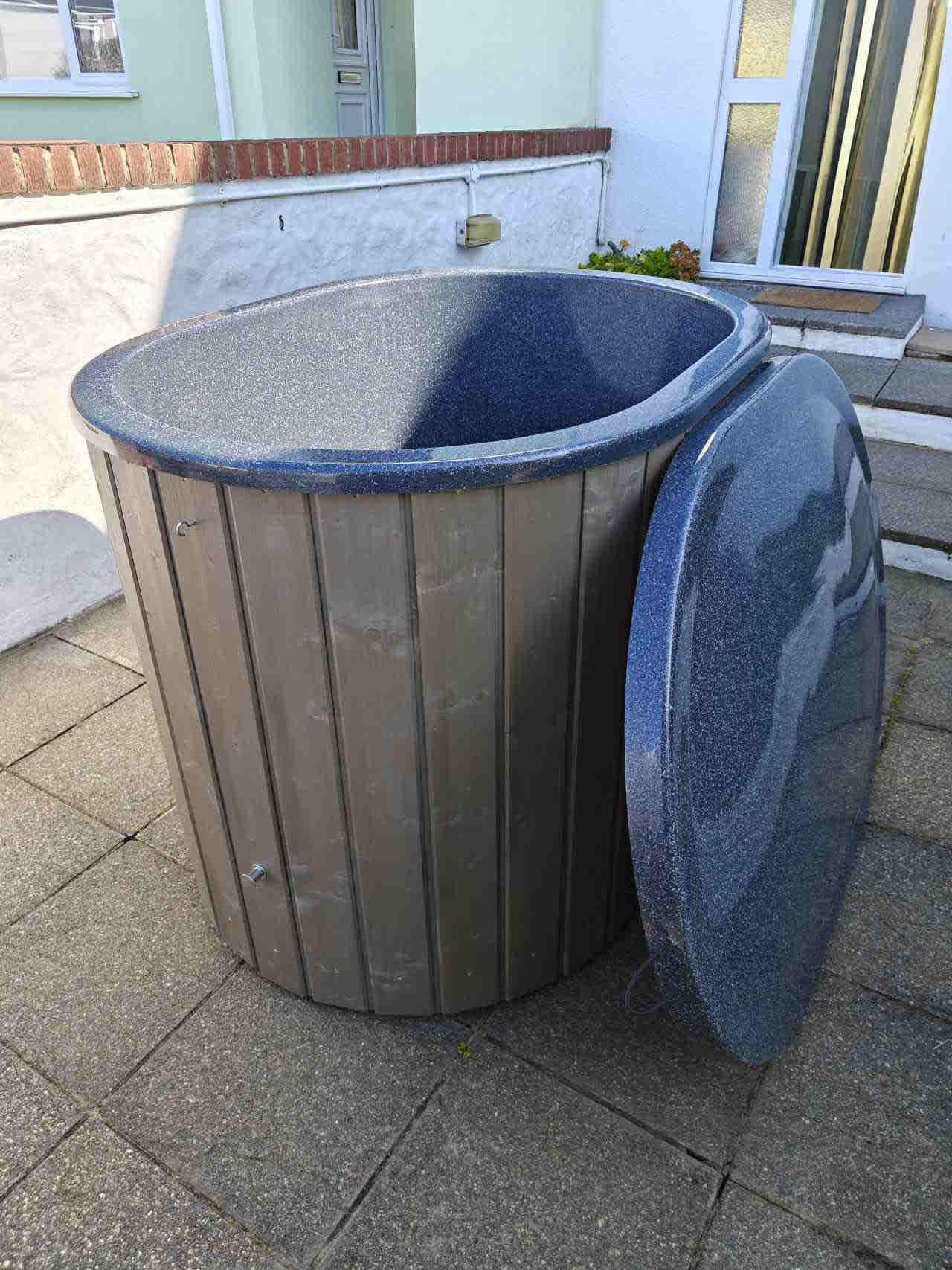 The Labrum cold plunge tub featuring a deep Pearlescent Blue interior and integrated exterior drainage valve for quick water discharge.